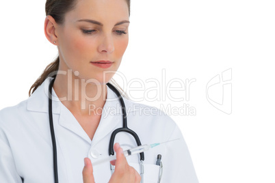 Serious nurse holding a syringe