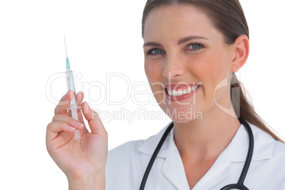Happy nurse holding a syringe and smiling