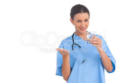 Happy surgeon holding medicine and glass of water