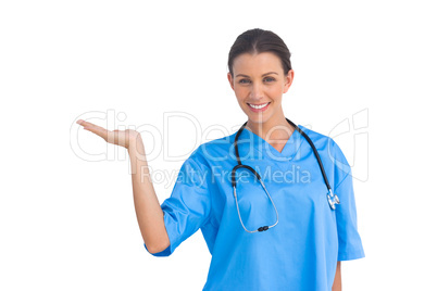 Surgeon holding up hand in presentation and smiling at camera