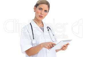 Annoyed nurse using tablet pc