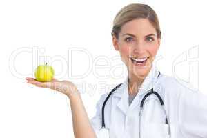 Laughing nurse with apple on her hand