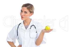 Nurse holding green apple