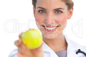 Focus shot on nurse holding apple