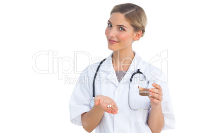 Nurse showing drugs and water glass