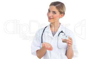 Nurse showing drugs and water glass