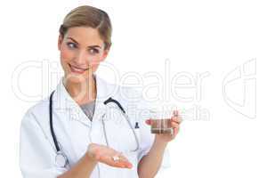 Nurse presenting drugs and water glass