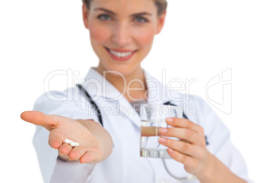 Drugs and water glass held by nurse