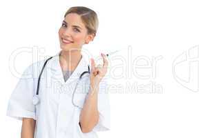 Smiling nurse preparing syringe