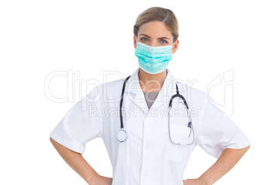 Nurse wearing surgical mask with hands on hips