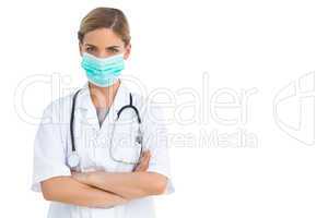 Nurse wearing protective mask with arms crossed