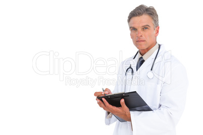 Man doctor writing on clipboard with pen