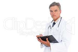 Man doctor writing on clipboard with pen