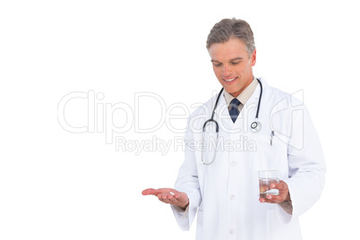 Doctor looking at drugs and water glass