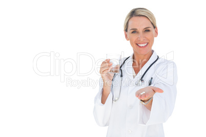 Smiling doctor holding out pills and water glass
