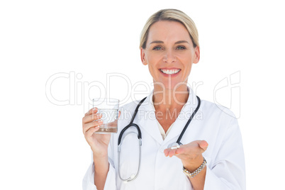 Doctor with medication and a glass of water in her hands