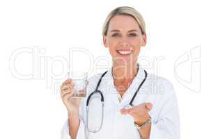 Doctor with medication and a glass of water in her hands