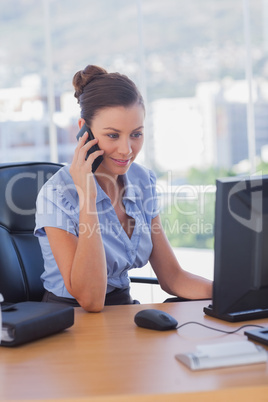 Smiling businesswoman calling