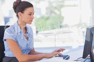 Serious businesswoman working on her computer