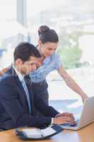 Business people working together with a laptop