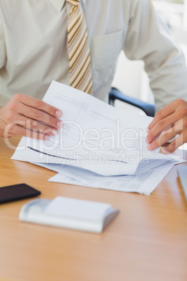 Hands of businessman turning a page