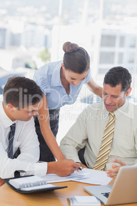 Smiling business people working together on a document