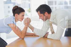 Business people arm wrestling