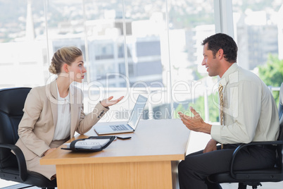 Businesswoman interviewing a smiling businessman