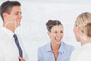 Happy business people laughing together