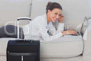 Business woman lying on couch and looking at camera