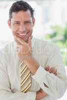 Businessman smiling with hand on chin