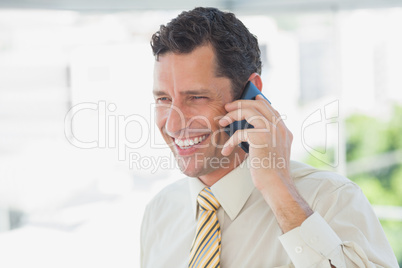 Laughing businessman on the phone