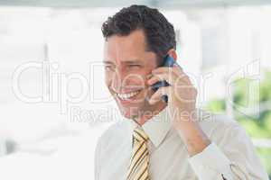 Laughing businessman on the phone