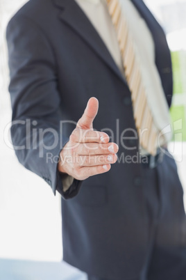 Businessman extending arm for handshake