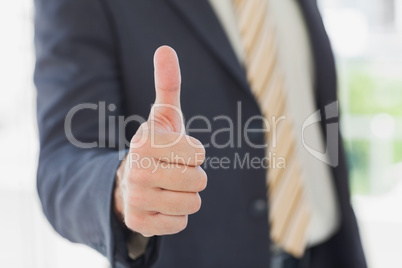 Businessman giving thumbs up