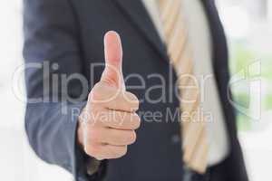 Businessman giving thumbs up