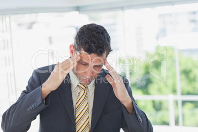 Businessman rubbing his temples