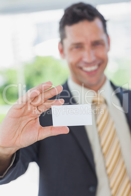 Businessman showing a white business card