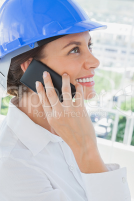 Smiling architect having a phone conversation