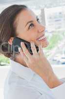 Smiling businesswoman having a phone conversation