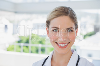 Beautiful smiling doctor standing in her office