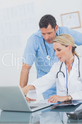 Blonde woman showing something on a laptop to her colleague