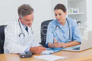 Two doctors working on an important folder