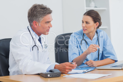 Two doctors discussing and working together