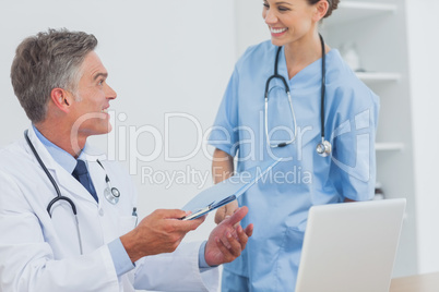 Smiling doctor talking to a colleague