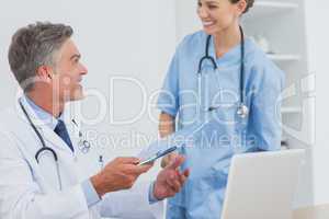 Smiling doctor talking to a colleague