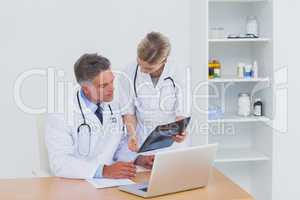 Nurse showing a radiography to her colleague