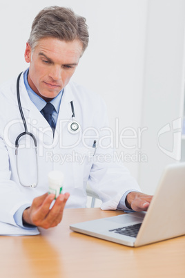 Doctor holding a bottle of pills