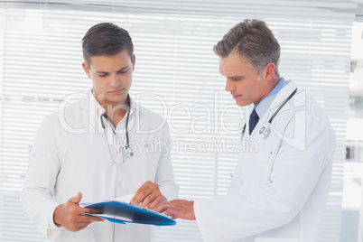 Doctors reading a folder