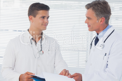 Smiling doctors holding a folder